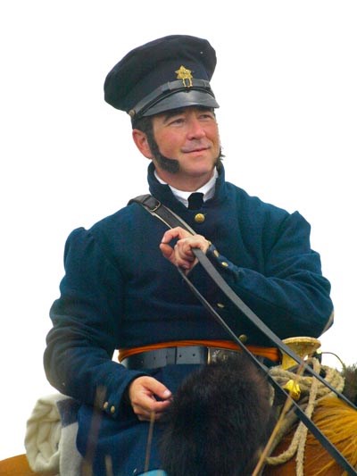 Man in blue uniform riding on horse