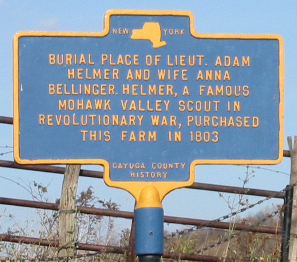 A blue and yellow NYS historic marker with the words 