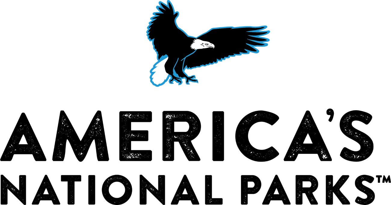 A large eagle lands on a block of letters that read "America's National Parks TM"