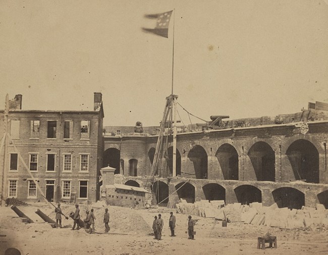 Interior shot from parade ground of Fort Sumter after the evacuation of Major Anderson's Union garrison. First National Confederate flag flying over fort.