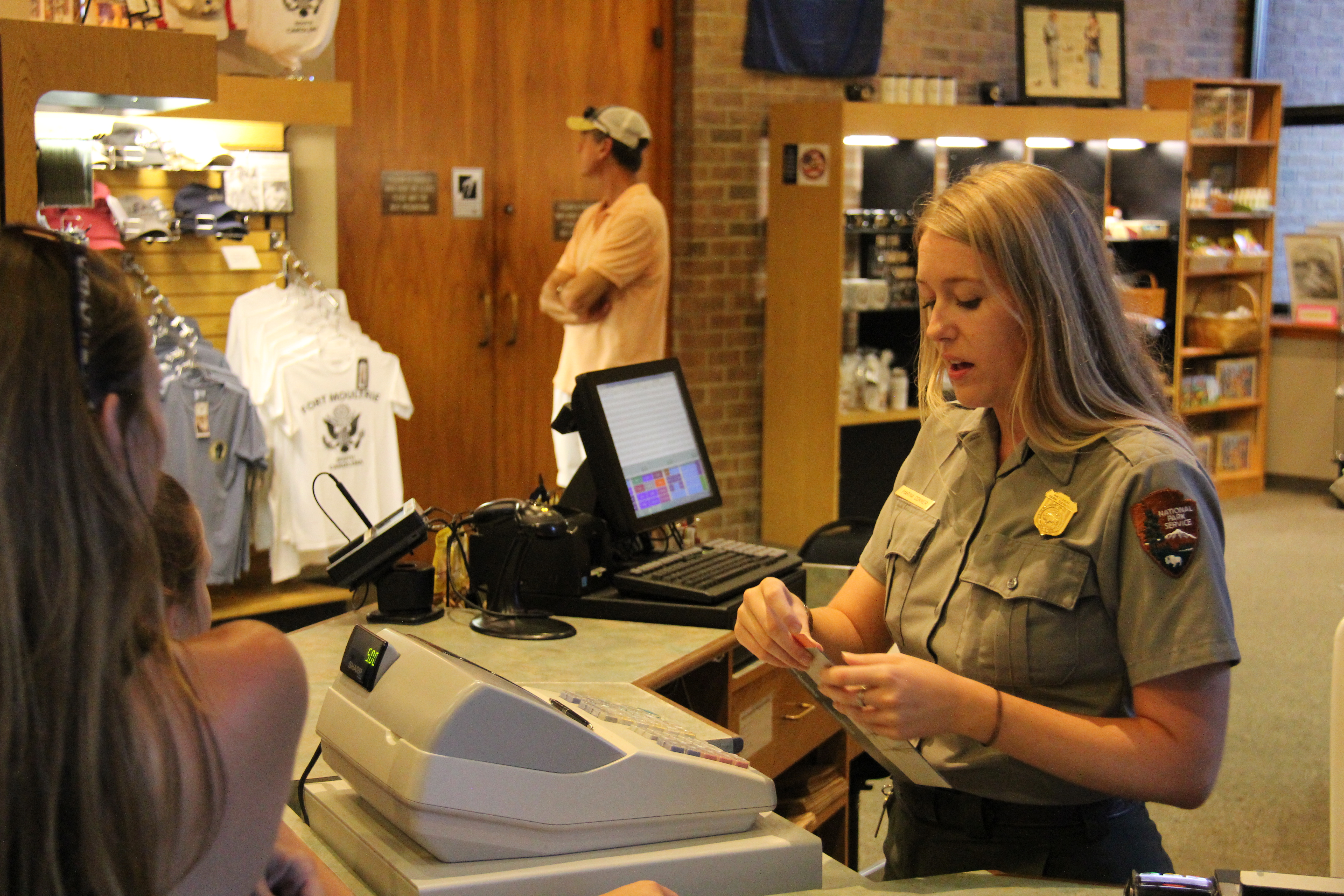 Ranger collecting entrance fee at Fort Moultrie visitor center desk
