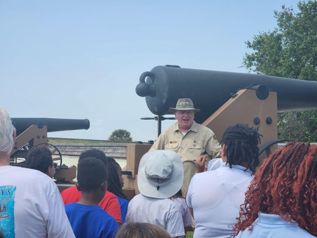 Volunteer speaking with visitors