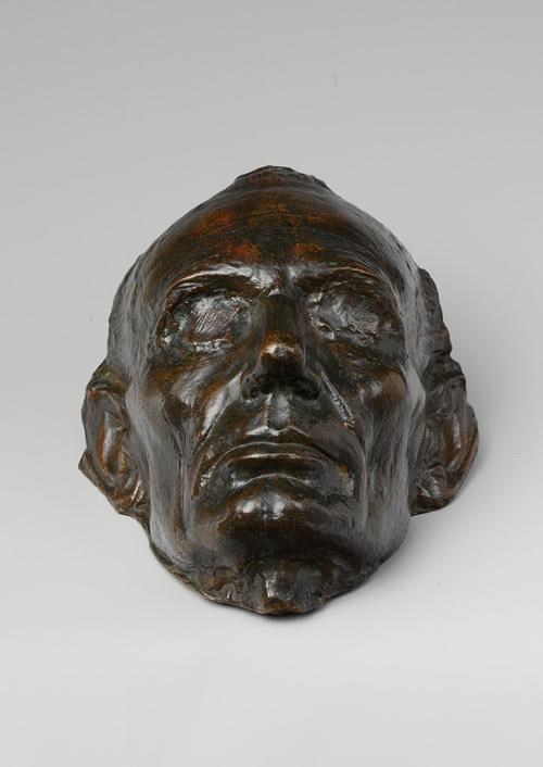 Bronze metal life mask of a clean shaven man's face