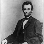 Lincoln seated facing the camera in black and white image