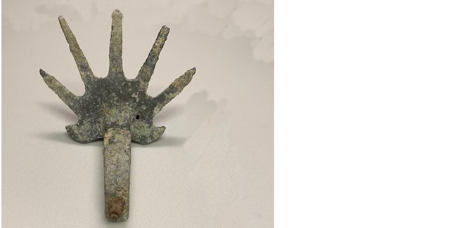 metallic object that looks like hand with fingers spread out