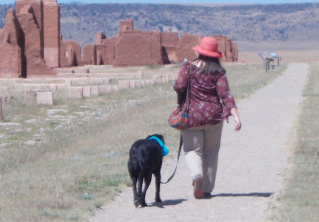 Laura Harvey and her dog Fred exploring the historic remnants of Fort Union.