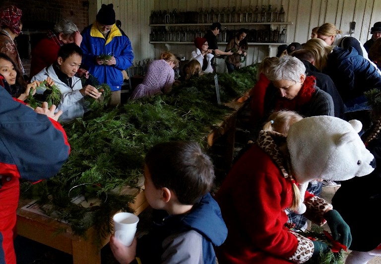 Visitors make wreaths and enjoy hot cider in the Bakehouse - Credit Joe Blanco