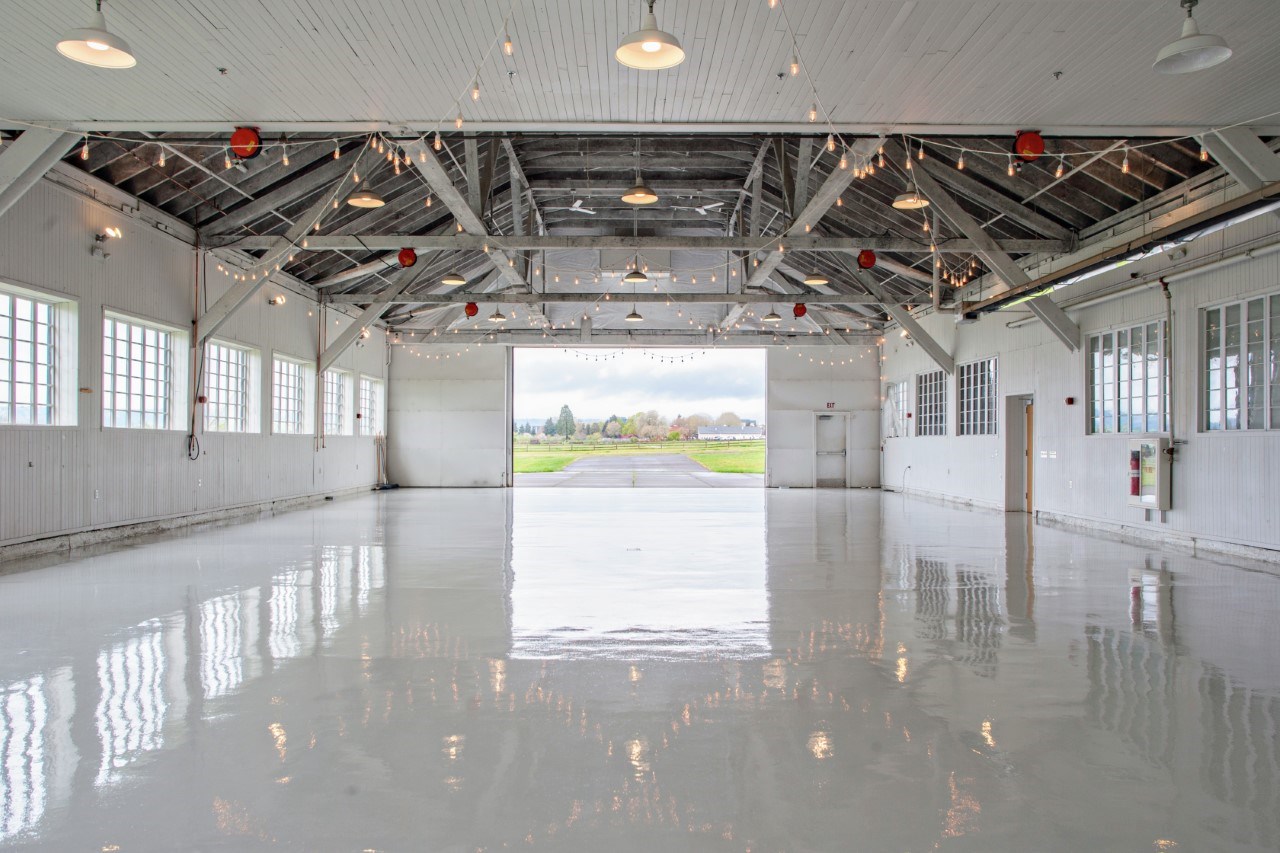 Inside the Historic Hangar with a view out the hangar doors facing west.