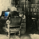 A graphic of Frederick Douglass working on a computer at his desk
