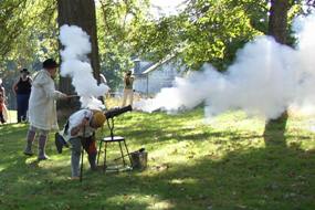 Re-enactors firing cannon