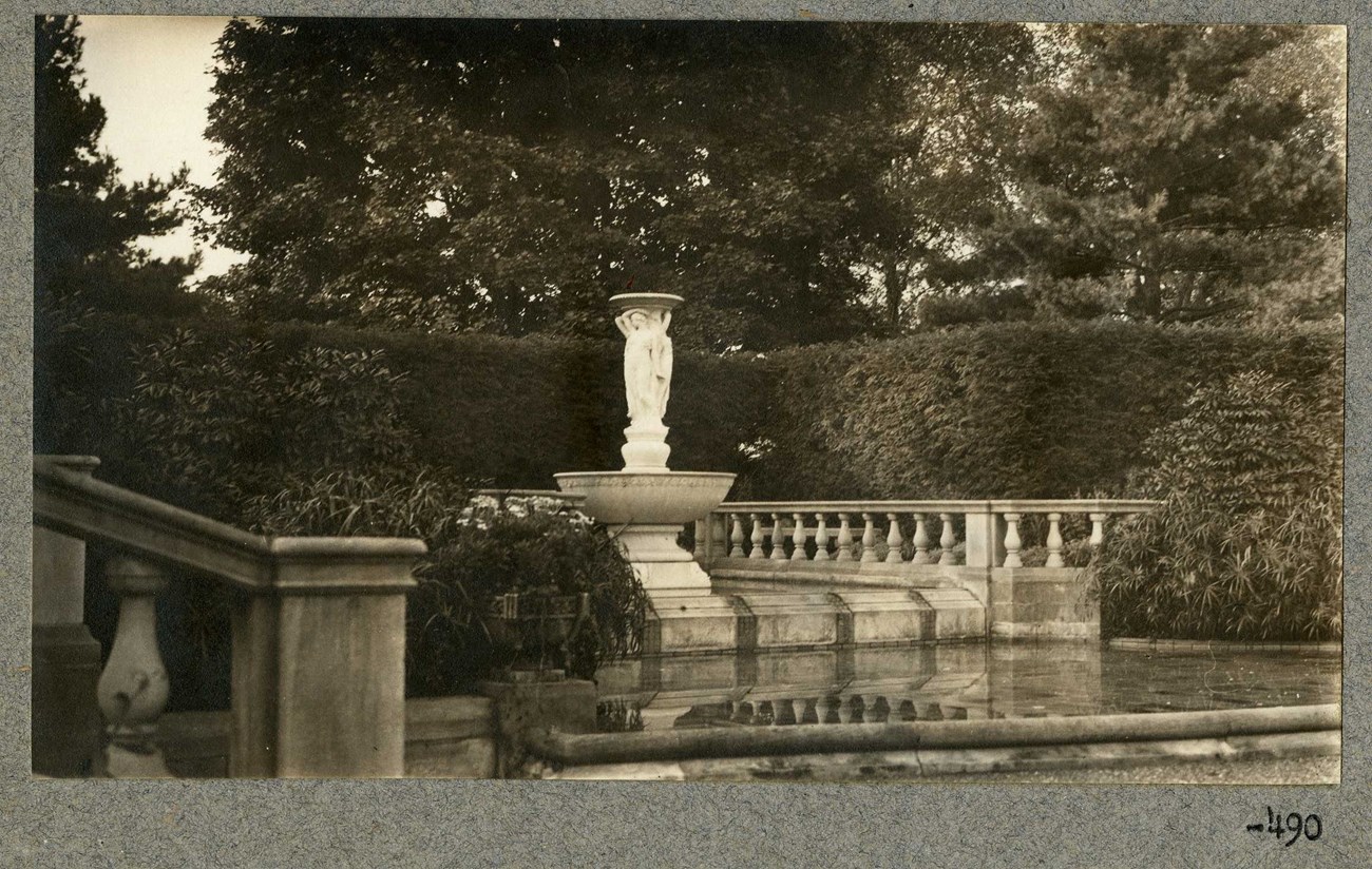 Fountain of the three graces surrounded by garden scenery