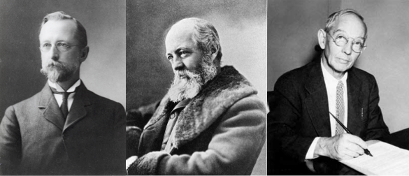 Black and white photograph of three men. All are posing in dark suits.