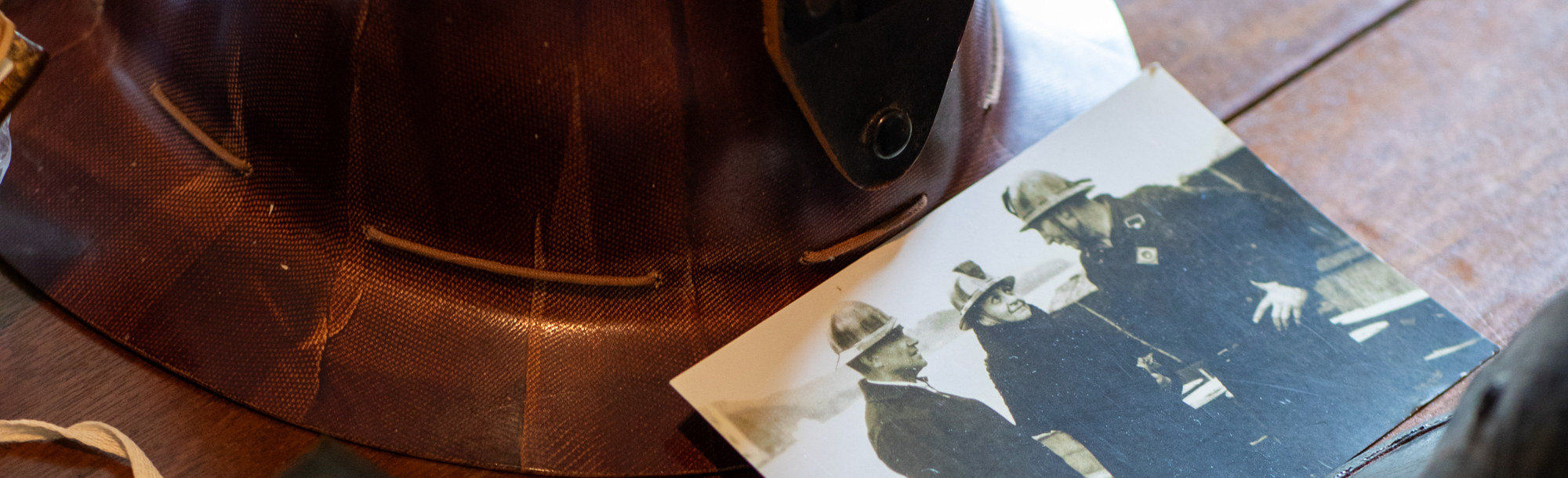 Frances Perkins and group of men wearing safety helments.