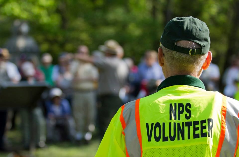 Volunteer in yellow traffic vest helping with special event