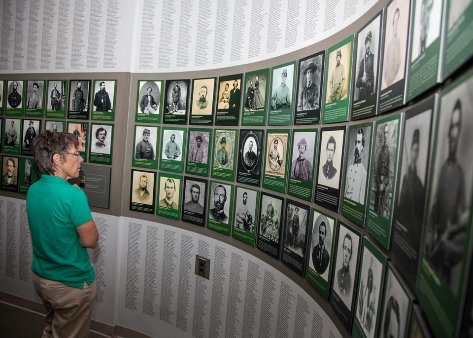 Visitor contemplates Wall of Faces exhibit at Chancellorsville Visitor Center
