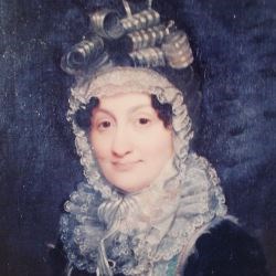 Portrait of Hannah Coalter from shoulders up, wearing dark dress and bonnet