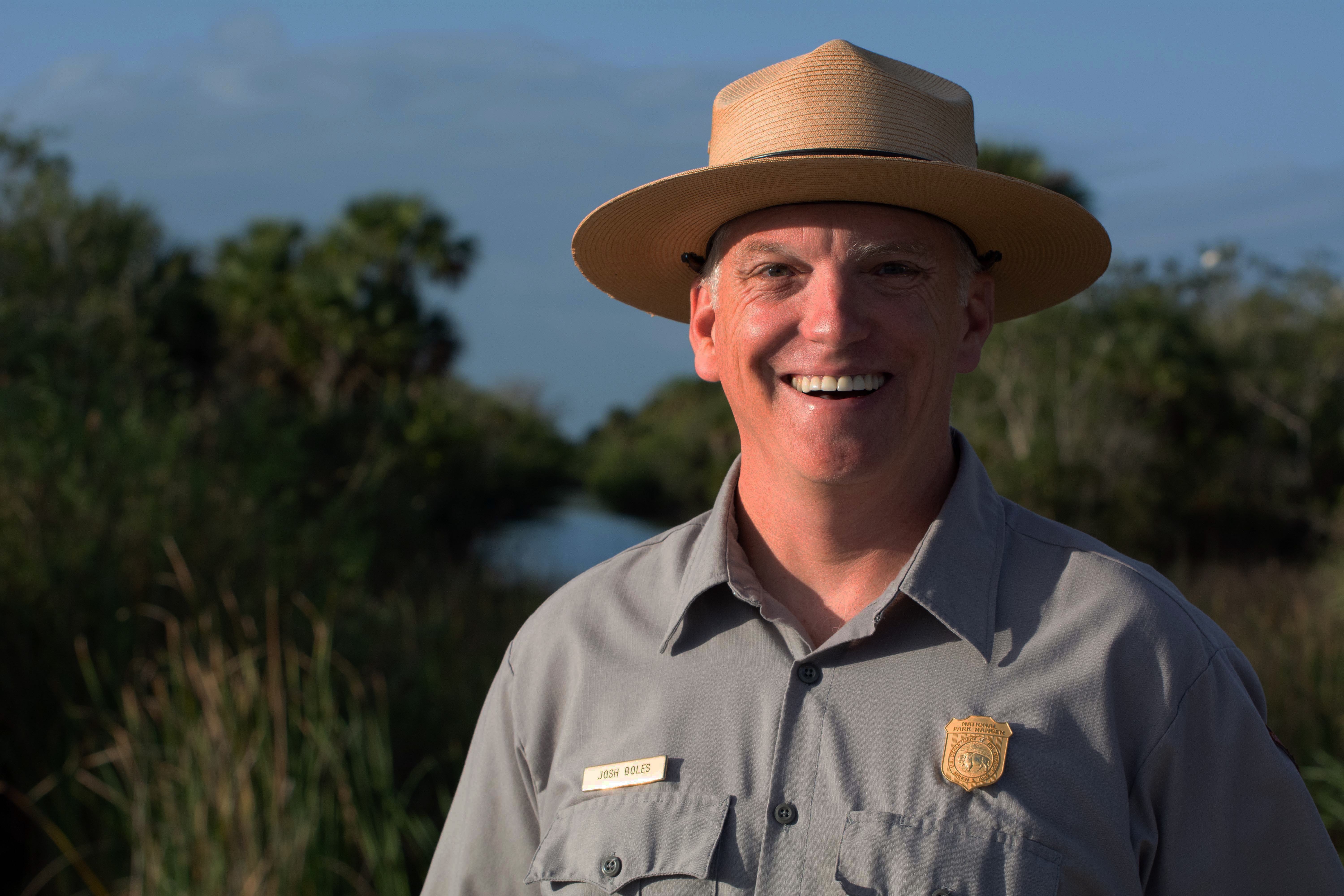 A man in a uniform smiles