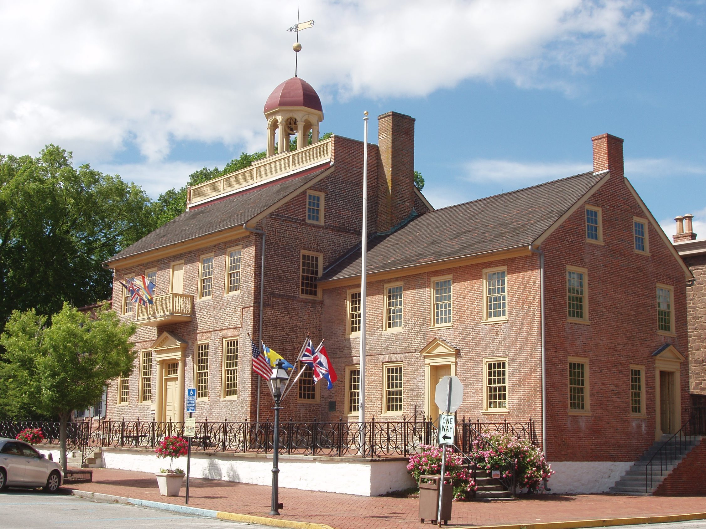 The front and right side of the New Castle Court House are shown on a bright sunny day.