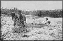 Pulling canoe up Kobuk River