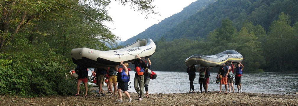 visitors carrying rafts