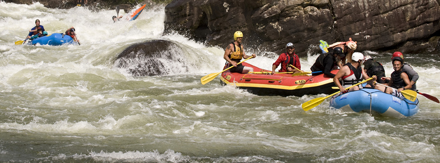 Rafters and kayakers in whitewater