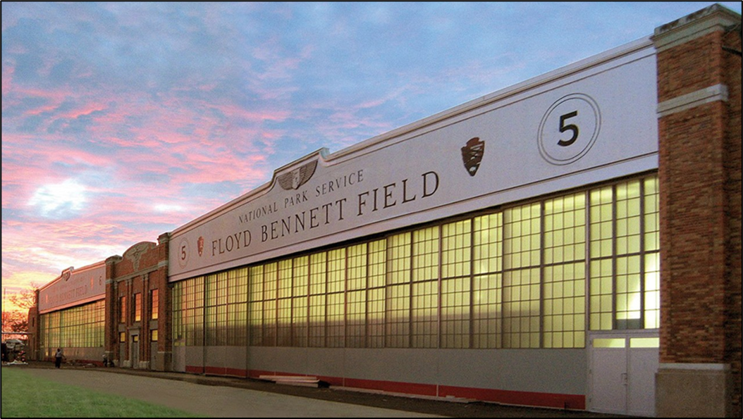Two large historic buildings with sunset reflected in their windows