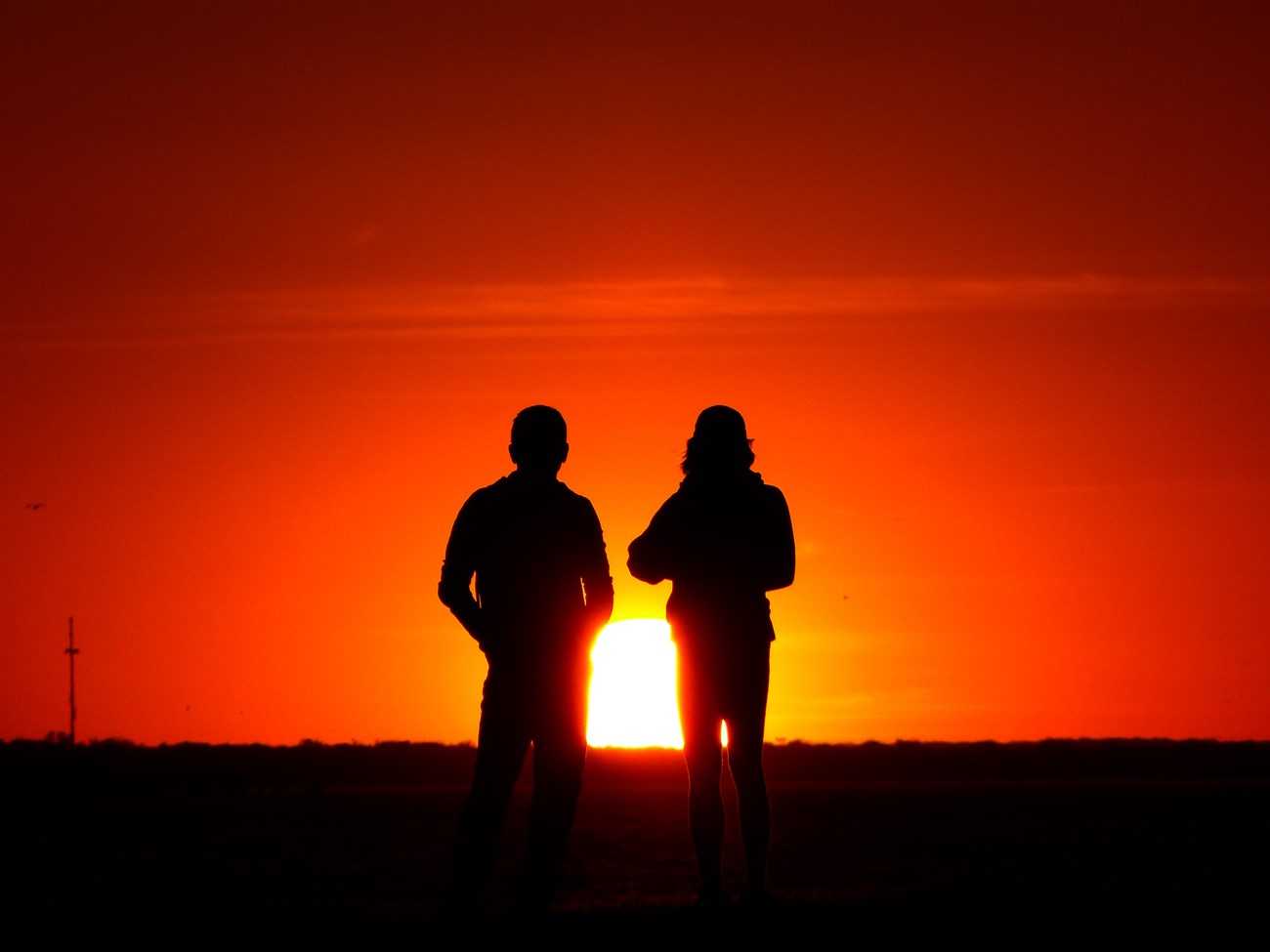 Silhouette of couple in front of a sunset