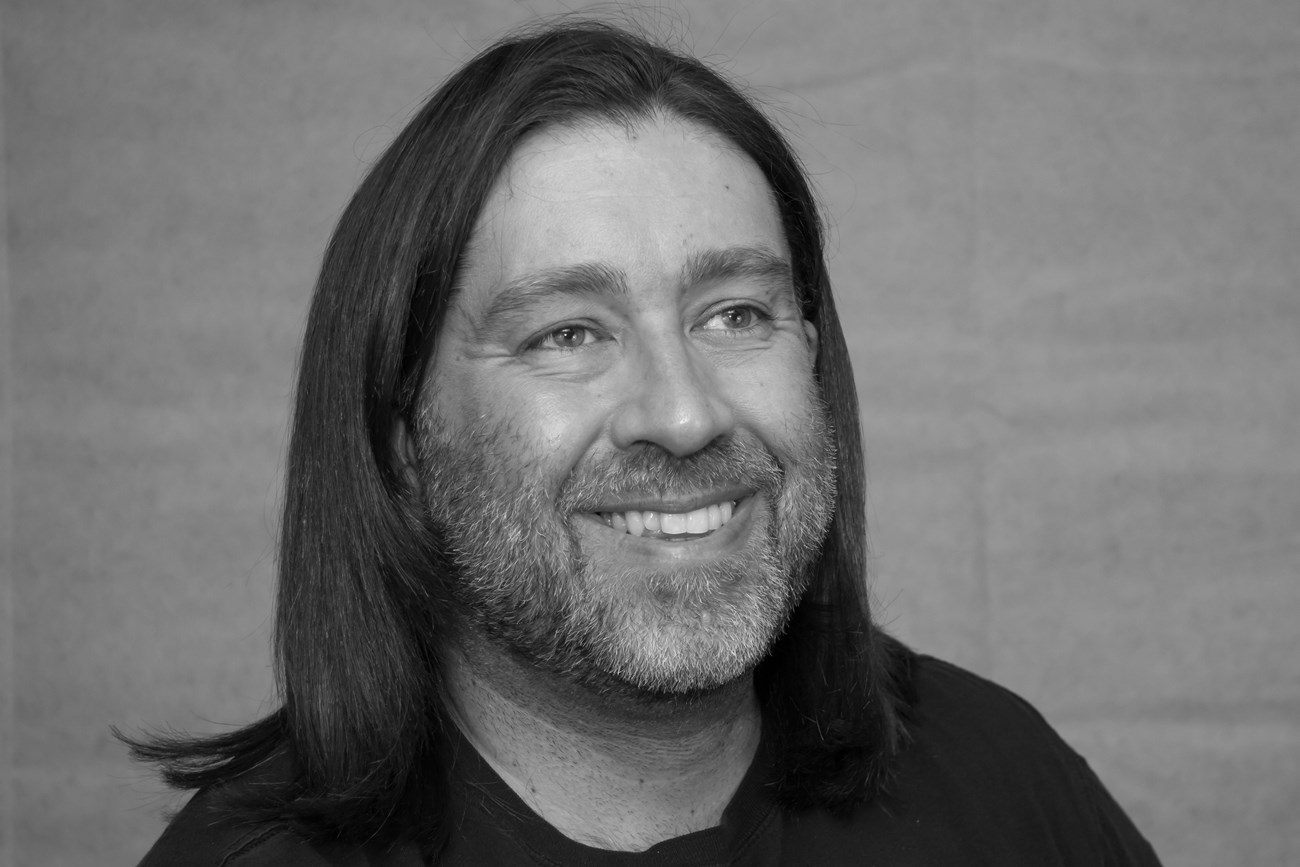 Black and white photo of man with long hair