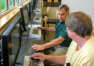 A park volunteer assists a visitor in the Resource Room.