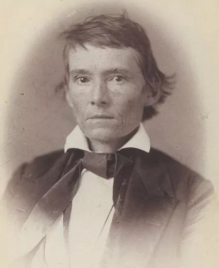 Black and white photo of a seated man
