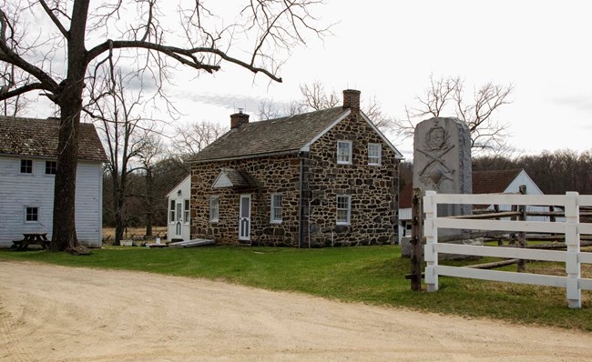 photo of a small stine house on a cloudy day