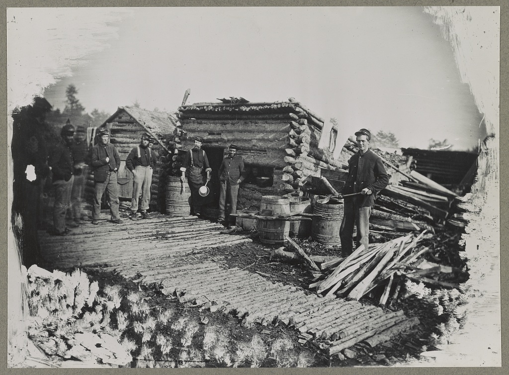 Civil War Soldiers in Camp of the 6th N.Y. Artillery at Brandy Station, Virginia; they are gathered in front of the camp kitchen