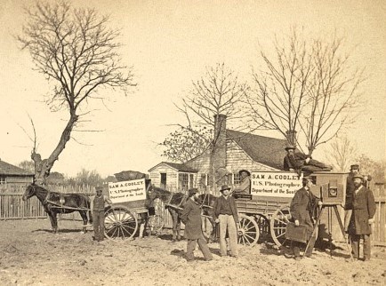 Photograph of a Civil War era photographer with wagon in camp with photography equipment