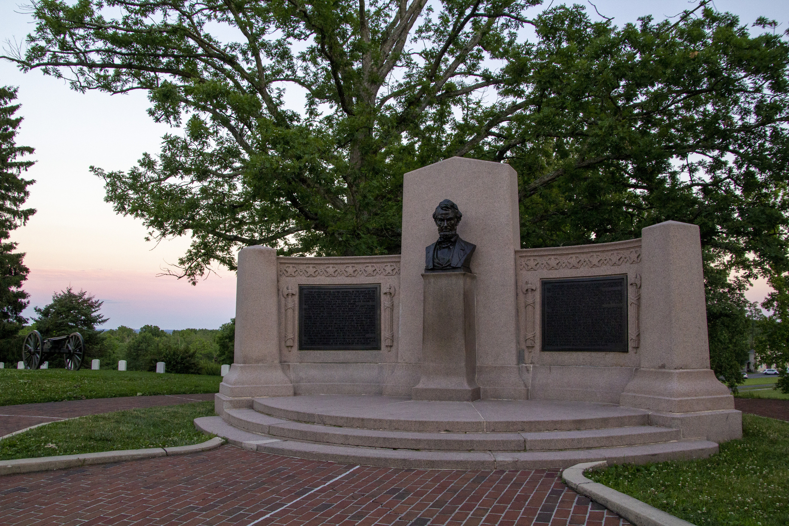Photograph showing granite Lincoln Speech Memorial with bronze bust portrait of Abraham Lincoln and bronze tablets, one inclluding the text of the Gettysburg Address