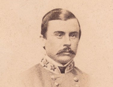 Black and white photograph of a man in a gray military coat