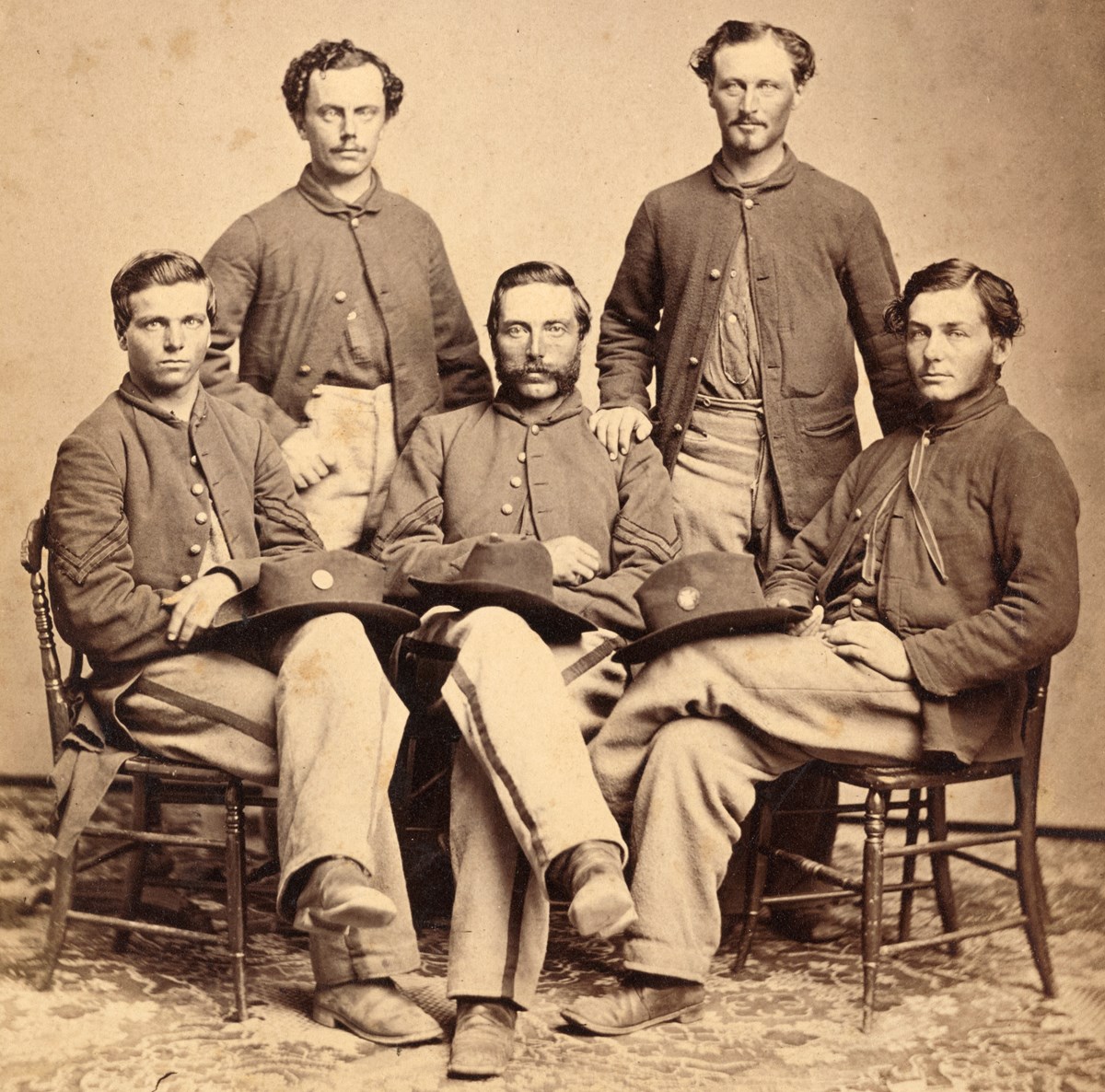 Five young United States Soldiers posing together in Civil War uniforms