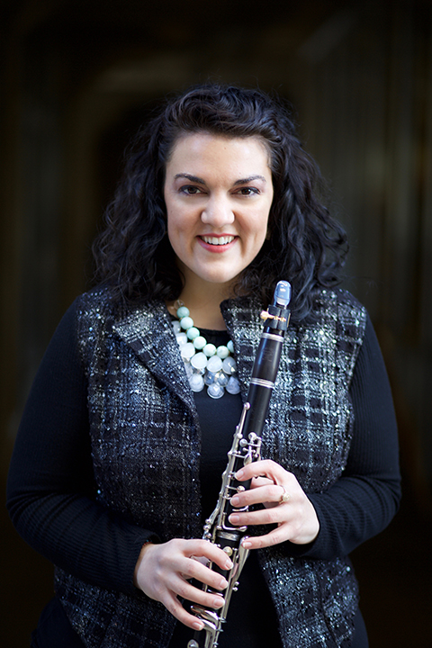 Clarinetist Anastasia Christofakis stands for a photograph holding her clarinet.