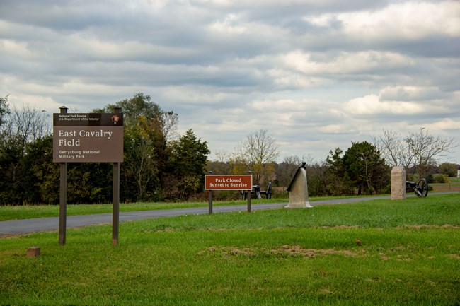 Signs and roads and monuments near grass