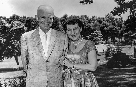 Dwight and Mamie Eisenhower stand arm in arm off the rear patio of their Gettysburg home.