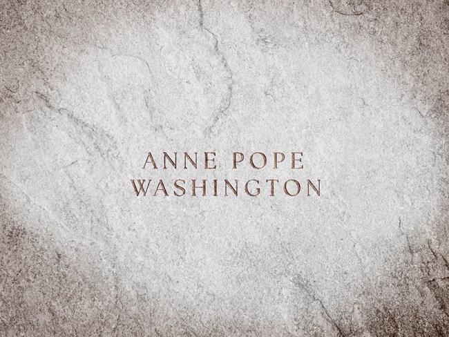 A stone slab with text engraved reads, "Anne Pope Washington"