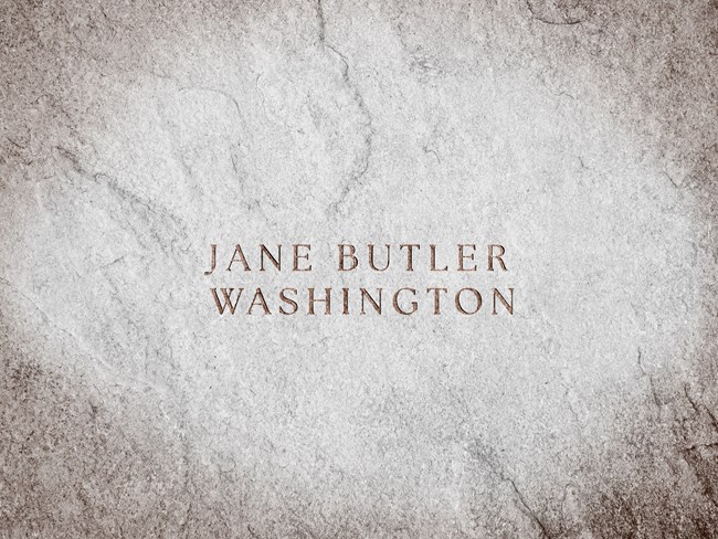 A stone slab with text engraved reads "Jane Butler Washington"