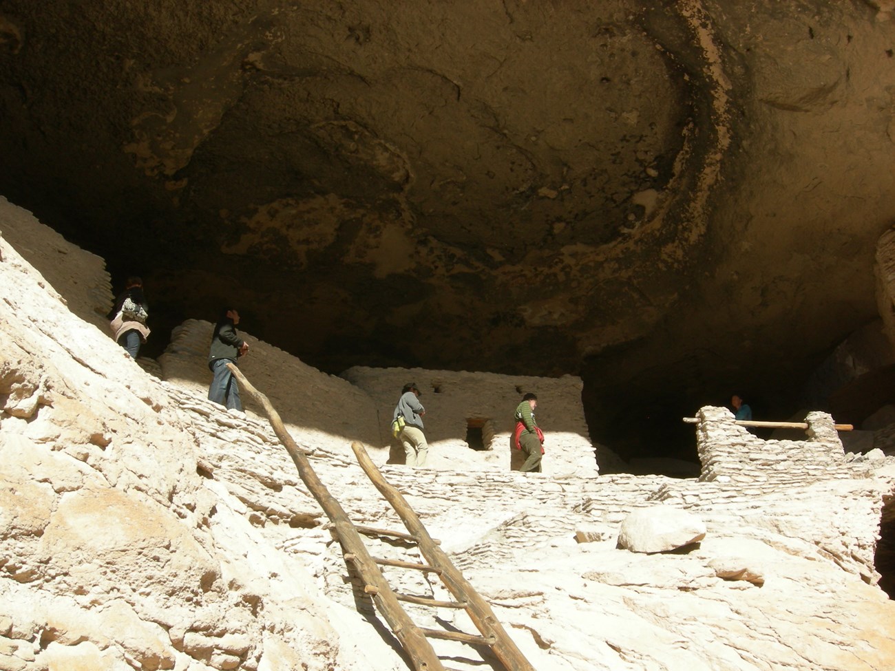Visitors explore Gila Cliff Dwellings.