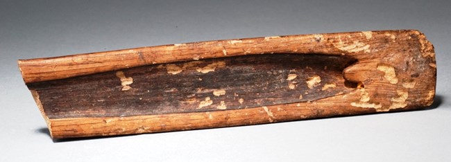A piece of wood carved out to aid with spear throwing