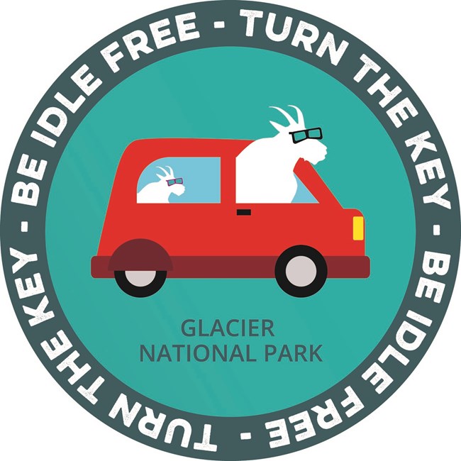 Round logo showing a red car with two cartoon goats as passengers and text around the outside reading 'Turn the key-be idle free'