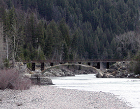 Bridge in distance arching over river