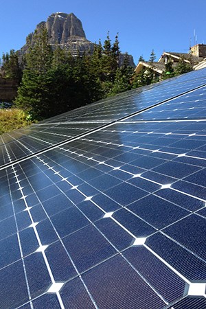 solar panel with mountain and roofline in background
