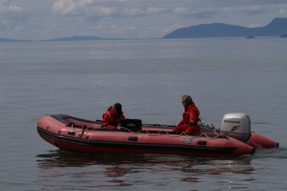 researchers in red inflatable boat