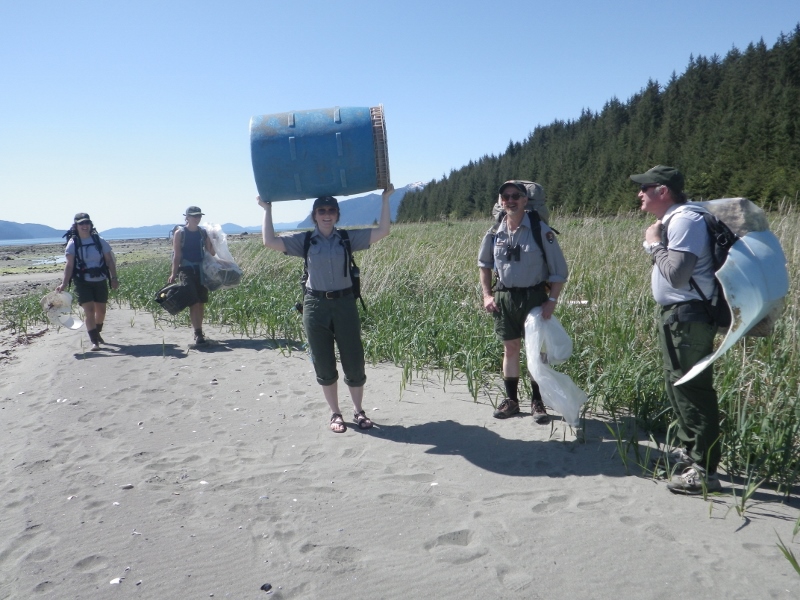 NPS staff collect trash on the beach