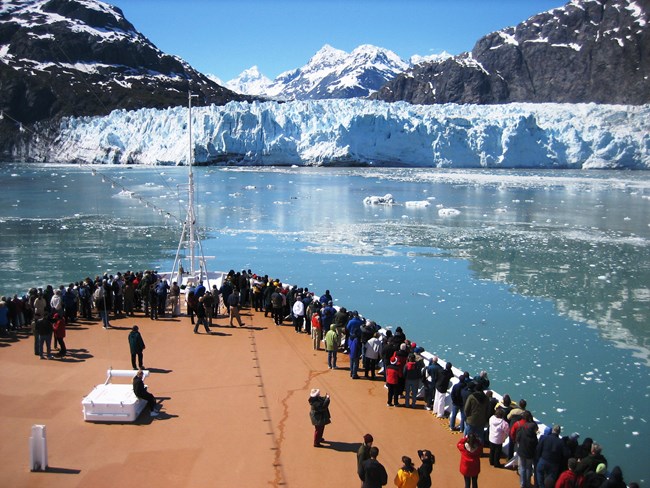 Passengers line at the bow of a cruise ship to view Margerie Glacier