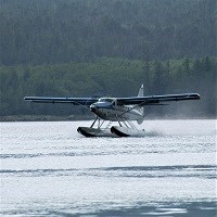 a float plane lands on water